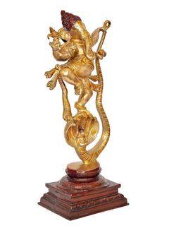 Brass Lord Ganesha dancing on Shesha serpent, raised hands and ornate gold ornaments