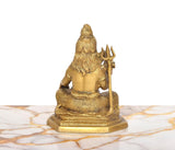 Brass Lord Shiva statue, rear view with long hair and trident, seated on round pedestal, 6.5-inch.