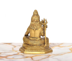 Brass Lord Shiva statue, rear view with long hair and trident, seated on round pedestal, 6.5-inch.