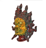 Brass Mahakala mask wall hanging, side profile with gold face and green ornaments