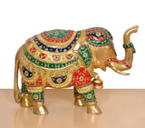 Brass elephant figurine front-right view, gold body with red, green, and blue patterned panels