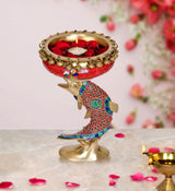 Brass urli bowl candle lamp with fish motif, red and blue patterned figure
