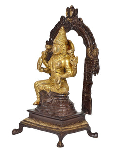 Brass Lakshmi idol statue, close view of golden deity and carved arch frame