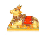 Resin Nandi cow idol side view, yellow cow with red saddle and jeweled gold collar