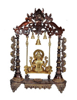 Brown Ganesha swing with gold-tone seated Ganesha, hanging bells and carved pillar legs