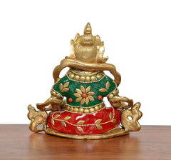 Rear view of brass Kubera statue with green top, red lower garment, and gold ornaments