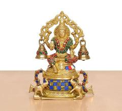 Brass Lakshmi statue front view, seated with four bells and jeweled multicolor accents
