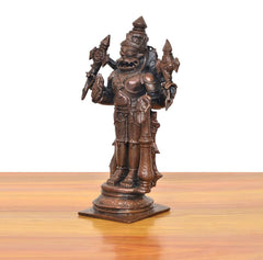 Side view copper Lord Narasimha standing idol, four arms raised with weapons