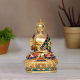 Brass Buddha figurine meditating with colorful beaded robe on lotus base