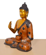 Brass Buddha idol side view, seated with Abhaya Mudra gesture and pot in lap