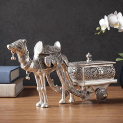 Silver metal camel with engraved harness pulling decorative cart with finial lid