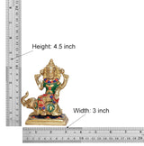 Brass deity idol with ruler, height 4.5 in and width 3 in measurements shown