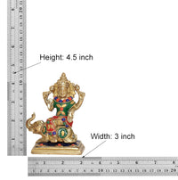 Brass deity idol with ruler, height 4.5 in and width 3 in measurements shown