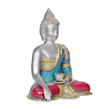 Brass Buddha idol holding a bowl with both hands, turquoise and red mosaic details