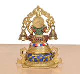 Brass Lakshmi statue rear view with arched crown frame, bells, and multicolored jewelry