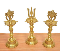 Brass diya shankh oil lamps with chakra and naama symbols, detailed stepped bases
