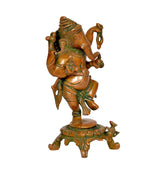Angled view of brass dancing Ganesha statue with green-gold trim and ornate pedestal
