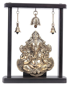 Ornate brass Ganesha idol wall hanging with dark wooden frame and bells