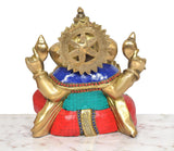 Rear view of brass Ganpati Bappa murti with circular halo and multicolor robe panel