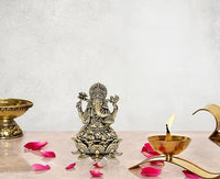 Brass Ganesha idol (3 inch) with ornate crown, seated on lotus base