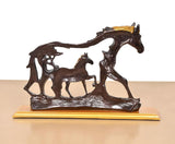 Resin horse figurine and foal, dark brown with gold mane, front angle on base.