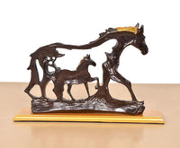 Resin horse figurine and foal, dark brown with gold mane, front angle on base.