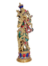 Brass Lord Krishna idol angled view, decorated body with raised arms and ornaments