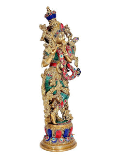 Brass Lord Krishna idol angled view, decorated body with raised arms and ornaments