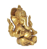 Brass Lord Ganesha idol, three-quarter view with trident-like hands, seated on lotus, 6 in