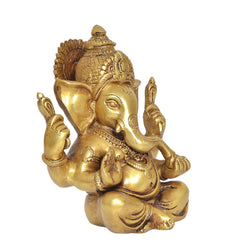 Brass Lord Ganesha idol, three-quarter view with trident-like hands, seated on lotus, 6 in