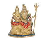 Angled view of brass Shiv Parivar idol with trident and seated family figures
