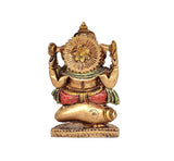 Back view of resin Ganesha showpiece, detailed crown and ornaments, seated on textured circular base