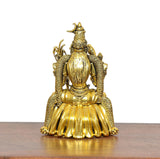 Golden brass goddess statue rear view, textured wings and curled ornament details