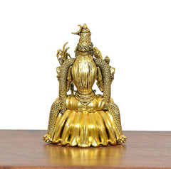 Golden brass goddess statue rear view, textured wings and curled ornament details
