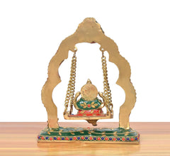 Brass Ganesha swing jhula statue, front view with multicolor base and gold-tone frame