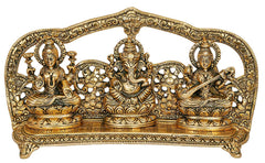 Gold-tone metal sculpture with central Ganesha flanked by Lakshmi and Saraswati