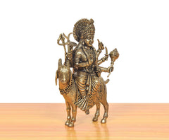Brass MATA idol statue on goat, three-quarter view with detailed face and drapery