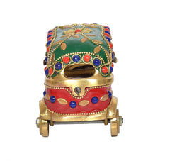 Brass auto rickshaw figurine with green roof and red lower panel, rear view