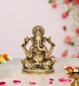 Gold-tone brass Ganesha idol, seated with four arms, ornate pedestal, 5.5 inch