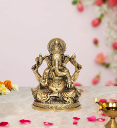Gold-tone brass Ganesha idol, seated with four arms, ornate pedestal, 5.5 inch