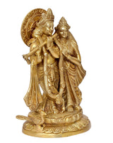 Brass Radha Krishna idol standing close together, intricate jewelry and carvings
