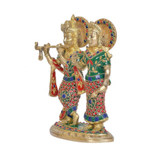Brass Radha-Krishna idol from side: Krishna plays flute, Radha with raised arm; ornate details