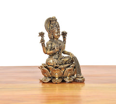 Back/angled view of Lakshmi murti seated on lotus, raised hand and beaded detailing