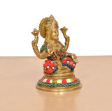 Brass Lakshmi idol statue, angled view with red-and-blue patterned arm accents.