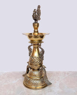 Brass peacock diya stand front view with upper bowl and textured engraved base