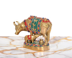 Brass cow with calf idol, side view with green panel, red details, jeweled border