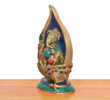 Brass Ganesha conch murti, side view, colorful jeweled details on blue mosaic back