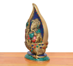 Brass Ganesha conch murti, side view, colorful jeweled details on blue mosaic back