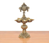 Ornate bronze five-diya oil lamp stand with detailed finial and central stem
