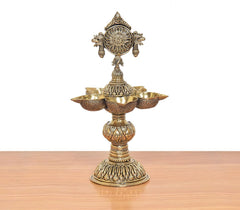 Ornate bronze five-diya oil lamp stand with detailed finial and central stem